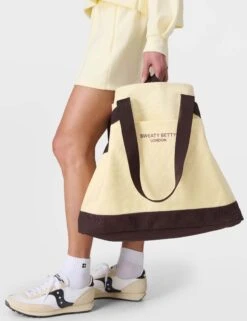 Sweaty Betty SB Canvas Bucket Bag - Buttercream Yellow -The Sports Edit sweaty betty sb canvas bucket bag buttercream yellow sb10224 7